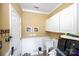 Functional laundry room with white cabinets, a utility sink, and modern appliances for convenient home care at 625 Circle Trace Rd, Monroe, NC 28110