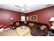 Comfortable living room with dark red walls, plush seating, and a neutral carpet at 625 Circle Trace Rd, Monroe, NC 28110