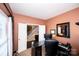 Bright home office featuring modern black desk and black leather chair and view of stairs through open double doors at 625 Circle Trace Rd, Monroe, NC 28110