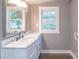 Modern bathroom featuring a marble vanity top, sleek fixtures, and a framed mirror reflecting natural light at 6282 Richburg Rd, Great Falls, SC 29055