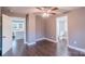 Bedroom with hardwood floors, fan, and view to kitchen and bathroom at 6282 Richburg Rd, Great Falls, SC 29055