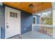 Covered front porch with white railings and a light fixture with wood ceiling at 6282 Richburg Rd, Great Falls, SC 29055