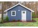 View of a backyard shed with dark siding, white trim and a gable roof, surrounded by landscaping at 6282 Richburg Rd, Great Falls, SC 29055