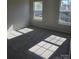 Sunlit bedroom featuring neutral walls, carpeted flooring, and a large window with backyard views at 649 Favorwood Dr, Rock Hill, SC 29730