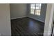 Well-lit bedroom with neutral walls, modern flooring, and large window at 649 Favorwood Dr, Rock Hill, SC 29730