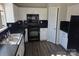 Well-lit kitchen features black appliances, light countertops, and stainless steel sink at 649 Favorwood Dr, Rock Hill, SC 29730