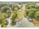 Aerial view of the property showcasing its waterfront location, a pond, a private dock, and surrounding greenery at 7790 Blackwood Rd, Denver, NC 28037