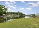 Scenic waterfront view featuring a calm river, green trees, boat docks and a well-maintained lawn at 7790 Blackwood Rd, Denver, NC 28037