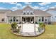 Charming home featuring a backyard patio, landscaped garden beds, and cozy outdoor seating at 7900 Creek Park Dr # 109, Denver, NC 28037