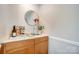 Cozy bar area featuring wood cabinets, sink, and a selection of beverages for entertaining at 8250 Tradd Ct, Charlotte, NC 28210