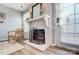 Charming brick fireplace with white mantle and decorative screen adds warmth to the living space at 8250 Tradd Ct, Charlotte, NC 28210