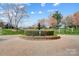 Brick roundabout features a lush fountain and beautiful landscaping in a well-maintained community at 8250 Tradd Ct, Charlotte, NC 28210