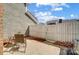 Cozy patio with an outdoor table set, fenced area, brick building and manicured mulch landscape at 8250 Tradd Ct, Charlotte, NC 28210