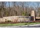 Elegant stone entrance to Griffith Lakes community with manicured landscaping and a welcoming sign at 9408 Munsing Dr # 149, Charlotte, NC 28269