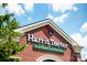 Close-up of a Harris Teeter store's exterior featuring brick architecture and clear blue skies at 9408 Munsing Dr # 149, Charlotte, NC 28269