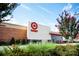 Exterior view of a Target store featuring red and white branding, brick accents, and greenery at 9408 Munsing Dr # 149, Charlotte, NC 28269