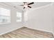 Well-lit bedroom with hardwood floors and two windows at 9650 Liberty Hill Dr, Mint Hill, NC 28227