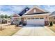 Close-up showcasing the two-car garage and partial brick facade of this inviting home at 9650 Liberty Hill Dr, Mint Hill, NC 28227