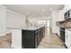 Kitchen island with granite countertop and stainless steel sink overlooking the living area at 9650 Liberty Hill Dr, Mint Hill, NC 28227