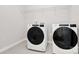 Laundry room includes modern washer and dryer with overhead storage at 9650 Liberty Hill Dr, Mint Hill, NC 28227