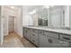 A spacious bathroom featuring double vanities, granite countertops, and tile floors at 117 Cramerton Mills Pkwy, Cramerton, NC 28032