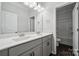 A bright bathroom featuring double vanities, white countertops, and wood floors at 117 Cramerton Mills Pkwy, Cramerton, NC 28032