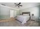 Spacious primary bedroom with a ceiling fan, neutral carpet, and natural light at 117 Cramerton Mills Pkwy, Cramerton, NC 28032