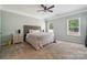 Spacious primary bedroom with a ceiling fan, neutral carpet, and natural light at 117 Cramerton Mills Pkwy, Cramerton, NC 28032