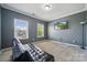 A gray bedroom with a leather futon and two windows at 117 Cramerton Mills Pkwy, Cramerton, NC 28032