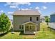 A well-maintained yard complements the neutral toned siding of this home's rear exterior at 117 Cramerton Mills Pkwy, Cramerton, NC 28032