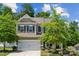 Charming two-story home with a well-maintained front yard and a two-car garage at 117 Cramerton Mills Pkwy, Cramerton, NC 28032