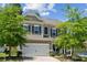 Charming two-story home featuring a welcoming front porch, manicured lawn, and a two car garage at 117 Cramerton Mills Pkwy, Cramerton, NC 28032