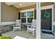 Inviting front porch featuring rocking chairs and stone accents at 117 Cramerton Mills Pkwy, Cramerton, NC 28032