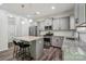 Well-equipped kitchen with stainless steel appliances, granite counters, and island seating at 117 Cramerton Mills Pkwy, Cramerton, NC 28032