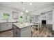 Bright kitchen open to living area, granite island, stainless appliances, and modern finishes at 117 Cramerton Mills Pkwy, Cramerton, NC 28032
