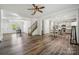 Open-concept living area with hardwood floors and seamlessly connecting kitchen and dining at 117 Cramerton Mills Pkwy, Cramerton, NC 28032