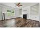 Cozy living room with a fireplace, built-in shelves, and ample natural light at 117 Cramerton Mills Pkwy, Cramerton, NC 28032