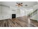 Spacious living room featuring fireplace, built-in bookshelves, and hardwood floors at 117 Cramerton Mills Pkwy, Cramerton, NC 28032
