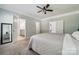 Large main bedroom with neutral carpet, ceiling fan, and en-suite bathroom access at 117 Cramerton Mills Pkwy, Cramerton, NC 28032