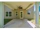 Covered patio with ceiling fan provides a cool space overlooking the home's backyard at 117 Cramerton Mills Pkwy, Cramerton, NC 28032
