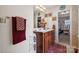 Bathroom featuring a double sink vanity, red accents, and access to the walk-in closet at 12502 Bending Branch Rd, Charlotte, NC 28227