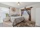 Cozy bedroom featuring a patterned bedspread, window, and warm natural light at 12502 Bending Branch Rd, Charlotte, NC 28227