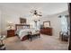 Spacious main bedroom featuring a ceiling fan, carpet, and a large window for natural light at 12502 Bending Branch Rd, Charlotte, NC 28227