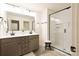 Bathroom with double sink vanity, large mirror, and glass-enclosed shower at 13024 Suncreek Ter, Charlotte, NC 28214