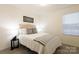 Bright bedroom featuring neutral decor, a comfortable bed, and a window with natural light at 13024 Suncreek Ter, Charlotte, NC 28214