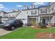 Charming two-story townhome with a well-manicured lawn and a bright yellow front door at 13024 Suncreek Ter, Charlotte, NC 28214