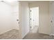 Bright hallway and adjoining laundry room with practical flooring and neutral colors at 13024 Suncreek Ter, Charlotte, NC 28214