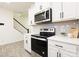 Well-lit kitchen featuring stainless steel appliances, white cabinets, and modern backsplash at 13024 Suncreek Ter, Charlotte, NC 28214