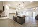 Modern kitchen with stainless steel appliances, white cabinets, and island with barstool seating at 13024 Suncreek Ter, Charlotte, NC 28214