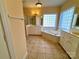 A serene bathroom features dual sinks, a soaking tub, and tiled floors, offering a peaceful retreat at 1419 Ridge St, Albemarle, NC 28001